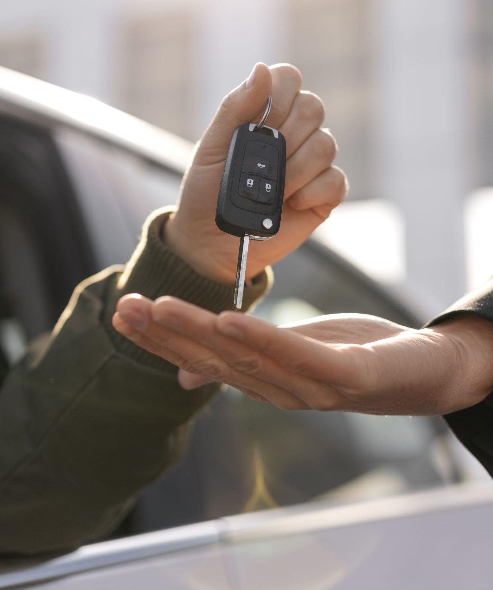 side-view-hands-holding-car-key
